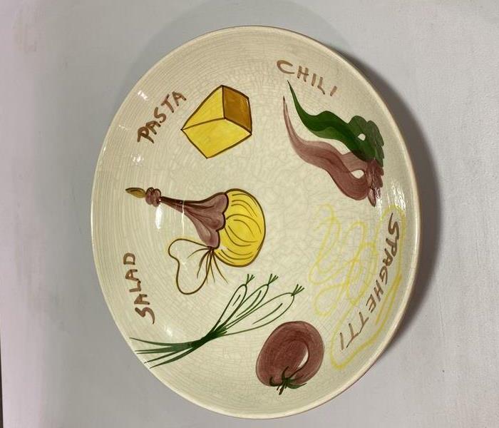 Painted flower dish cleaned of soot