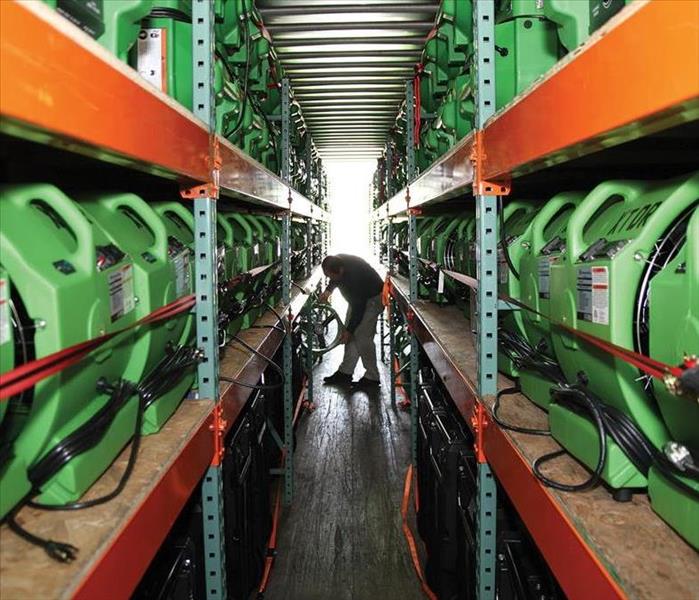 Row of green air movers stacked on shelves